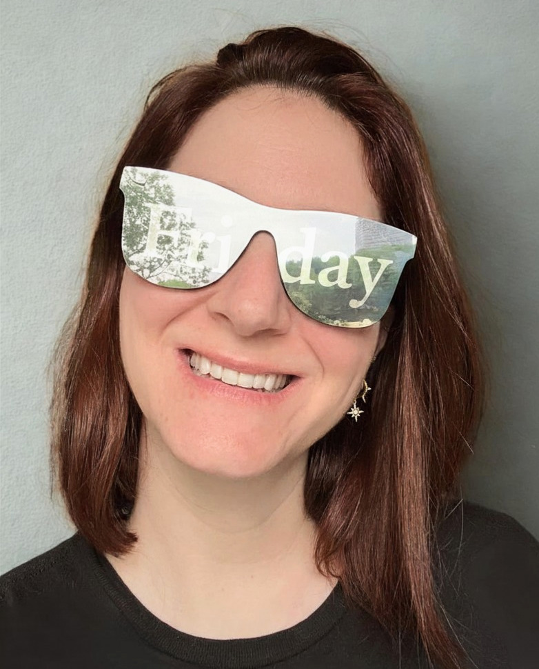 Leigh, founder of Finish by Fri.day, smiling in sunglasses with the word Friday across the lenses